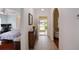 Open hallway with tile flooring leads to a bedroom, living room, and a view of the front yard through the front door at 2710 93Rd E Ct, Palmetto, FL 34221