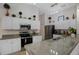 Charming kitchen featuring stainless appliances, granite counters, and ample cabinet space at 2710 93Rd E Ct, Palmetto, FL 34221