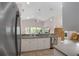 Bright kitchen area flowing into Gathering room, offering a serene view of the backyard at 2710 93Rd E Ct, Palmetto, FL 34221
