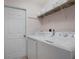 Laundry room featuring a washer, dryer, and shelving at 2710 93Rd E Ct, Palmetto, FL 34221