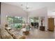 Bright living room with tile floors, ceiling fan, and access to the lanai at 2710 93Rd E Ct, Palmetto, FL 34221