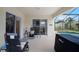 Relaxing covered patio area with comfortable seating, a view of the pool, and seamless indoor-outdoor living at 2710 93Rd E Ct, Palmetto, FL 34221
