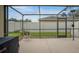 Screened-in patio with neutral-colored flooring, providing a space for relaxation and outdoor enjoyment at 2710 93Rd E Ct, Palmetto, FL 34221