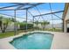 Sparkling screened-in pool with water feature, surrounded by palm trees and green grass at 2710 93Rd E Ct, Palmetto, FL 34221