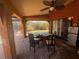 Covered patio with ceiling fan and outdoor seating next to the yard at 303 70Th Nw St, Bradenton, FL 34209
