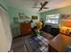 Cozy bedroom with blue accent wall, ceiling fan, wood flooring, and ample natural light at 3237 Pine Haven Dr, Clearwater, FL 33761