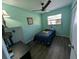 Bedroom featuring wood-look floors, a ceiling fan, a window, and a closet at 3237 Pine Haven Dr, Clearwater, FL 33761
