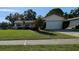 Charming single-story home with a well-manicured lawn, mature landscaping, and a two-car garage at 3237 Pine Haven Dr, Clearwater, FL 33761