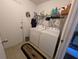 Laundry room with washer, dryer, and shelving for supplies at 3237 Pine Haven Dr, Clearwater, FL 33761