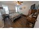 Comfortable main bedroom features wood-look floors, two windows, and a ceiling fan at 3237 Pine Haven Dr, Clearwater, FL 33761