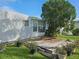 Backyard showcasing a modest deck with potted plants and a mature tree at 3324 Laurel Oak Way, Sarasota, FL 34237