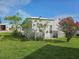 Backyard featuring a shade tree with grass and minimal landscaping at 3324 Laurel Oak Way, Sarasota, FL 34237