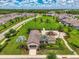 This aerial view showcases the community playground, green space, and surrounding residential neighborhood at 3602 Secret Stroll Dr, Sarasota, FL 34240