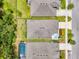 Aerial view highlighting the home's lush backyard landscaping with pool, along with the surrounding neighborhood at 3602 Secret Stroll Dr, Sarasota, FL 34240