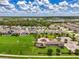 This overhead view highlights the surrounding homes, green spaces, and a playground, enhancing community appeal at 3602 Secret Stroll Dr, Sarasota, FL 34240