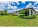 Well-manicured backyard featuring lush greenery and a charming screened-in lanai at 3602 Secret Stroll Dr, Sarasota, FL 34240