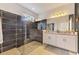 Modern bathroom with walk-in shower, black tile, and a granite countertop vanity at 3602 Secret Stroll Dr, Sarasota, FL 34240