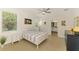 Bright bedroom with stylish decor, wood-look flooring, and ensuite bathroom access at 3602 Secret Stroll Dr, Sarasota, FL 34240