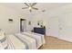 Bedroom featuring a dresser, ceiling fan, wood-look floors, and access to the bathroom at 3602 Secret Stroll Dr, Sarasota, FL 34240