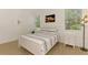 Bedroom with light wood-look flooring, a white bed frame and bright natural light at 3602 Secret Stroll Dr, Sarasota, FL 34240