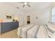 Bright bedroom features a dresser, wood-look flooring, ceiling fan, and natural light at 3602 Secret Stroll Dr, Sarasota, FL 34240