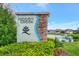 Community entrance sign 'Hidden Creek' with stone accents, landscaping and pond view, creating a welcoming atmosphere at 3602 Secret Stroll Dr, Sarasota, FL 34240