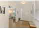 Bright entryway with neutral tile flooring, a jute rug, and a view into the adjacent living area at 3602 Secret Stroll Dr, Sarasota, FL 34240