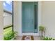 Light teal front door with glass pane and 'hi' door mat at 3602 Secret Stroll Dr, Sarasota, FL 34240
