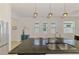 Modern kitchen with stainless steel appliances, pendant lighting, granite countertops, and seating at the island at 3602 Secret Stroll Dr, Sarasota, FL 34240