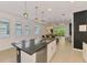 Modern kitchen with a granite island, stainless steel appliances, and ample natural light at 3602 Secret Stroll Dr, Sarasota, FL 34240