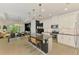 Modern kitchen with white cabinetry, granite countertops, stainless appliances, island with seating, and an open floorplan at 3602 Secret Stroll Dr, Sarasota, FL 34240