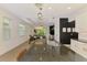 Open concept kitchen with granite counters, stainless appliances, and stylish pendant lighting at 3602 Secret Stroll Dr, Sarasota, FL 34240
