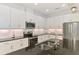 Modern kitchen with white cabinets, stainless steel appliances, and granite countertops at 3602 Secret Stroll Dr, Sarasota, FL 34240