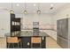 Kitchen features granite countertops, stainless steel appliances, pendant lighting, and seating at the island at 3602 Secret Stroll Dr, Sarasota, FL 34240