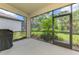 Screened-in lanai featuring a view of the yard and a grill with a cover at 3602 Secret Stroll Dr, Sarasota, FL 34240