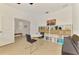 Bright room with a bookshelf filled with books and baskets, tile floors and a piano at 3602 Secret Stroll Dr, Sarasota, FL 34240