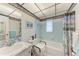 Cozy bathroom featuring a blue tiled shower and floral wallpaper accents at 3905 34Th Avenue W Dr # 36, Bradenton, FL 34205