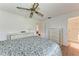 Bedroom with a ceiling fan, light-colored wood flooring, and an en suite bathroom with a glass shower at 3905 34Th Avenue W Dr # 36, Bradenton, FL 34205
