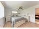 Bedroom featuring light-colored wood floors, a ceiling fan, two windows, and neutral decor at 3905 34Th Avenue W Dr # 36, Bradenton, FL 34205