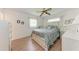 Bedroom with light-colored wood flooring, a ceiling fan, and two windows for natural light at 3905 34Th Avenue W Dr # 36, Bradenton, FL 34205