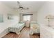 Bright bedroom featuring two twin beds with nautical-themed bedding and a decorative ceiling fan at 3905 34Th Avenue W Dr # 36, Bradenton, FL 34205