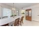 Dining room featuring tiled floors, seating for six, and a decorative china cabinet for storage at 3905 34Th Avenue W Dr # 36, Bradenton, FL 34205