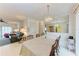 Bright dining area with a table for six, a large mirror, and a view into the living room at 3905 34Th Avenue W Dr # 36, Bradenton, FL 34205