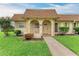 Charming home featuring a covered front porch with arched entryway and lovely landscaping at 3905 34Th Avenue W Dr # 36, Bradenton, FL 34205