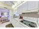 Efficient kitchen with an electric stovetop, white cabinetry, and a double basin sink with a yard view at 3905 34Th Avenue W Dr # 36, Bradenton, FL 34205