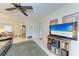 Open-concept living area connects to the dining room, featuring a large television and carpet at 3905 34Th Avenue W Dr # 36, Bradenton, FL 34205