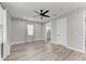 Spacious bedroom with a ceiling fan, light walls, and a peek into the en-suite bathroom at 4314 Des Plaines Dr, Sarasota, FL 34233
