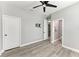 Neutral bedroom has wood-look floors, ceiling fan, adjacent bathroom, and closet at 4314 Des Plaines Dr, Sarasota, FL 34233