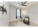 Relaxing bedroom features a chair, side table, window with blue curtains, and ceiling fan at 4314 Des Plaines Dr, Sarasota, FL 34233