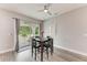 Bright dining area featuring a modern ceiling fan and sliding glass doors to the outdoor patio at 4314 Des Plaines Dr, Sarasota, FL 34233